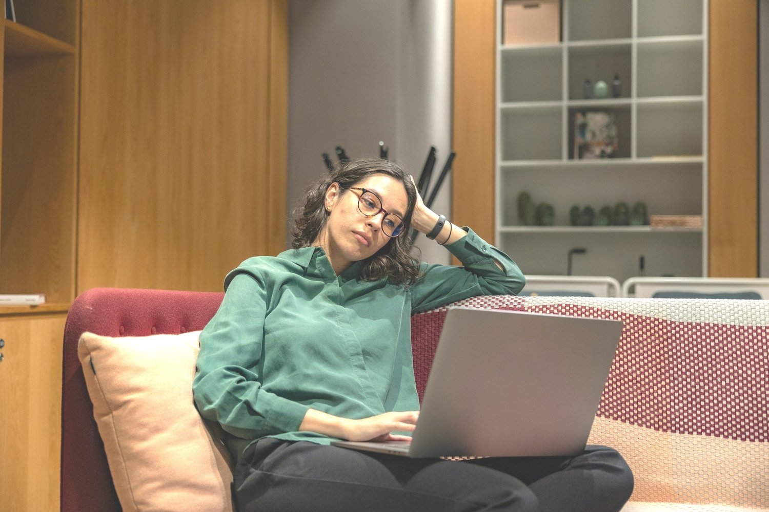 A woman working comfortably on a sofa