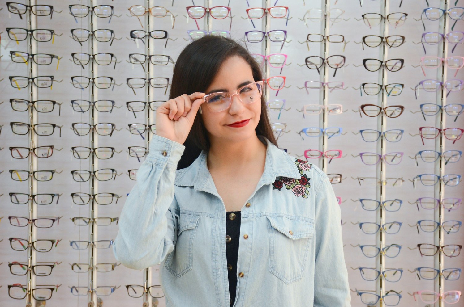 A woman choosing glasses in an optical practice